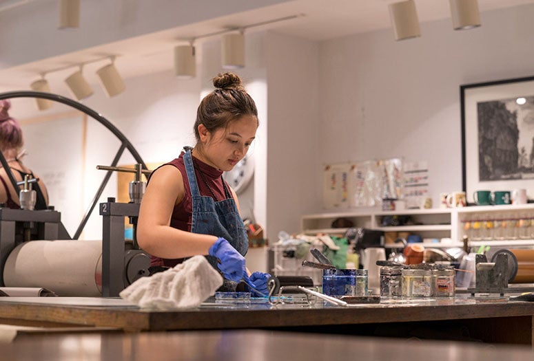 A VADA student works in Karin Broker's printmaking studio inside Sewall Hall. (Photo by Jeff Fitlow)