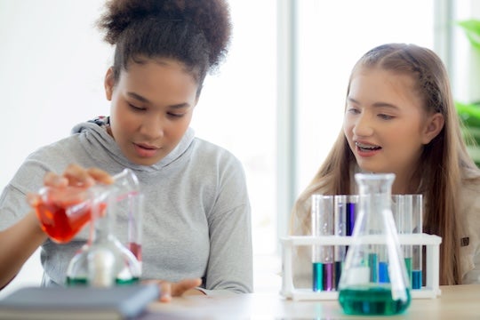 High school girls conducting a science experiment.