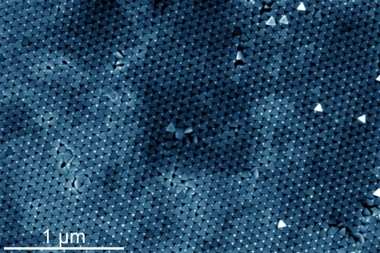 False-color SEM image showing hundreds of gold tetrahedral nanoparticles self-assembled in a 2D sheet