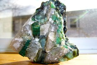Study: Crystals could grow up to a yard per day in some cooling magmas Rome wasn't built in a day, but some of Earth's finest gemstones were, according to new research from Rice University. Brazilian emeralds in a quartz-pegmatite matrix. (Photo courtesy of Madereugeneandrew/Wikimedia Commons) Aquamarine, emerald, garnet, zircon and topaz are but a few of the crystalline minerals found mostly in pegmatites, veinlike formations that commonly contain both large crystals and hard-to-find elements like tantalum and niobium. Another common find is lithium, a vital component of electric car batteries. "This is one step towards understanding how Earth concentrates lithium in certain places and minerals," said Rice graduate student Patrick Phelps, co-author of a study published online in Nature Communications. "If we can understand the basics of pegmatite growth rates, it's one step in the direction of understanding the whole picture of how and where they form." Pegmatites are formed when rising magma cools inside Earth, and they feature some of Earth's largest crystals. South Dakota's Etta mine, for example, features log-sized crystals of lithium-rich spodumene, including one 42 feet in length in weighing an estimated 37 tons. The research by Phelps, Rice's Cin-Ty Lee and Southern California geologist Douglas Morton attempts to answer a question that has long vexed mineralogists: How can such large crystals be in pegmatites? Cin-Ty Lee (Photo by Jeff Fitlow/Rice University) "In magmatic minerals, crystal size is traditionally linked to cooling time," said Lee, Rice's Harry Carothers Wiess Professor of Geology and chair of the Department of Earth, Environmental and Planetary Sciences at Rice. "The idea is that large crystals take time to grow." Magma that cools rapidly, like rock in erupted lavas, contains microscopic crystals, for example. But the same magma, if cooled over tens of thousands of years, might feature centimeter-sized crystals, Lee said. "Pegmatites cool relatively quickly, sometimes in just a few