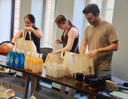 Rice University students and staff came together to pack care packages for refugees in Houston, offering essential supplies and a message of welcome and support.