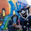 Sammy the Owl poses with mural artist GONZO247. (Photo by Brandon Martin)