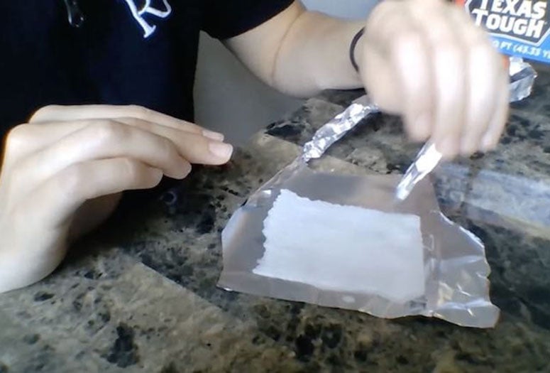 Student demonstrating an electrochemical reaction 