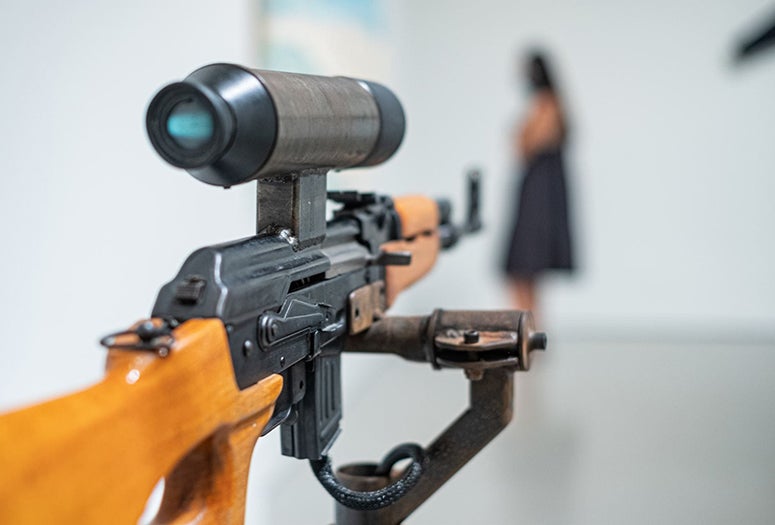 "America's Finest" by Lynn Hershman Leeson is an interactive installation with video camera and AK-47. (Photos by Jeff Fitlow)