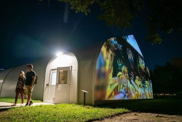 Rice students exit one of the temporary classrooms now hosting public art on campus. (Photo credit: Brandon Martin/Rice University)