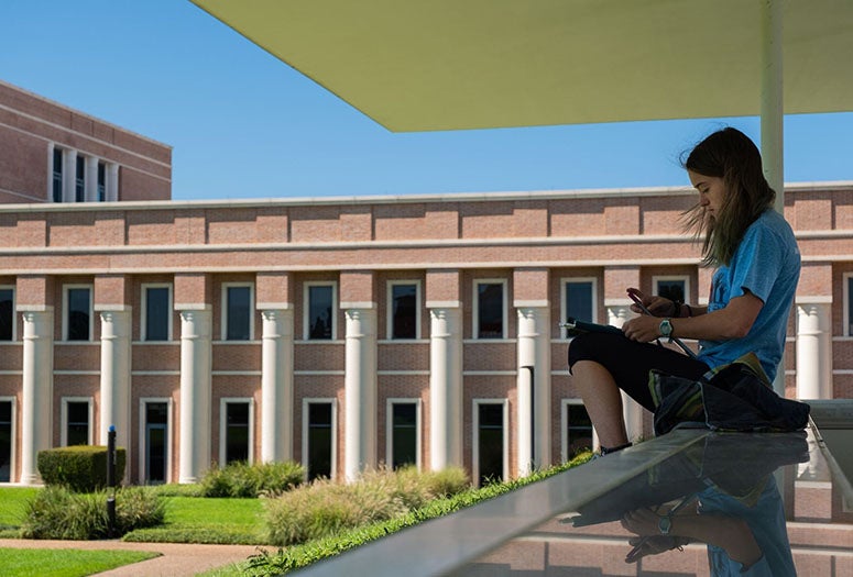 A Rice student sits on the James Turrell Skyspace to study. (Photo by Jeff Fitlow)