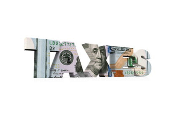 The word "taxes" with money imprinted on the letters. 
