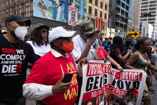 Protestors at the "Justice 4 George Floyd" march June 1 carry a banner in downtown Houston.