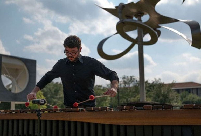 Shepherd School percussionist Aaron Smith performs a new composition by Shepherd School composer Theo Chandler inspired by Mark di Suvero's Po-um (Lyric). (Photo by Daniel Ortiz)