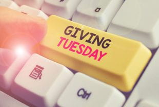 Key Pressing a key with "Giving Tuesday" printed on it 