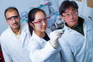 From left to right, Rice University postdoctoral researcher Saunab Ghosh, graduate student Natsumi Komatsu and professor Junichiro Kono and colleagues determined that grooves on filter paper cause nanotubes to align in highly ordered 2D films that were discovered in Kono's lab seven years ago. Finding the cause of the alignment clears the way for the production of higher-quality films that could be used to convert heat to electricity. (Photo by Jeff Fitlow/Rice University)