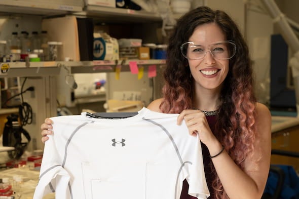 Rice University graduate student Lauren Taylor shows a shirt with carbon nanotube thread that provides constant monitoring of the wearer’s heart. Photo by Jeff Fitlow