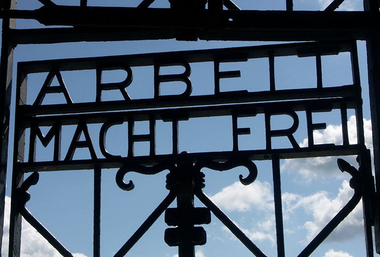 Fence with "Arbett Macht Fret" inscribed. Photo credit: Wikipedia