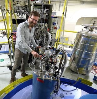 Johns Hopkins University physicist Wesley Fuhrman adjusting a cryostat on the MACS spectrometer used in inelastic neutron scattering experiments on CeRu4Sn6 at the NIST Center for Neutron Research in Gaithersburg, Md. (Photo by Yiming Qiu/NIST)