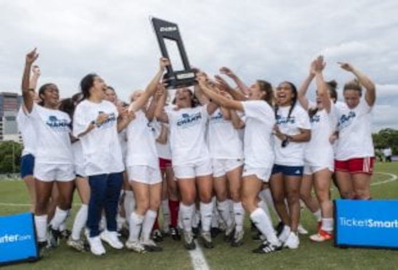 Rice players pose with the Conference USA trophy. (Photos by Tommy LaVergne)