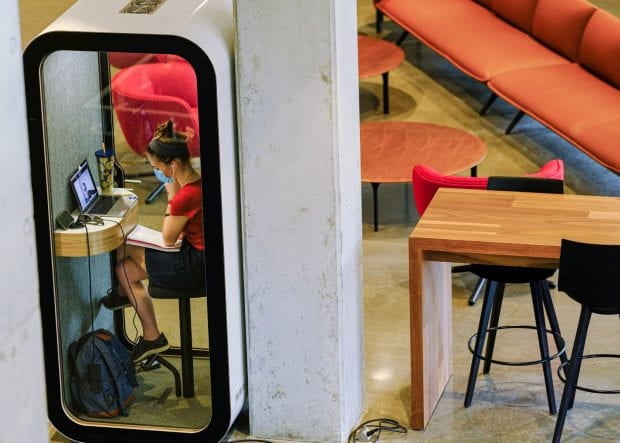 A Sidizen makes use of the new soundproof study booth on the ground floor of the new Sid Richardson College tower. The acoustic pod, the size of a phone booth, completely dampens all external noise but still allows in plenty of light.
