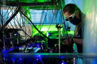 Rice University graduate student MacKenzie Warrens adjusts a laser-cooling experiment in Rice's Ultracold Atoms and Plasmas Lab. (Photo by Jeff Fitlow/Rice University)