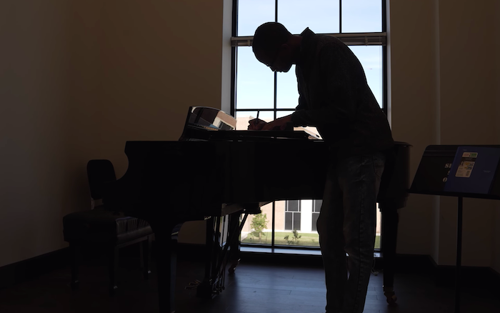 Jaylin Vinson composing at the piano. Photo credit: Brandon Martin