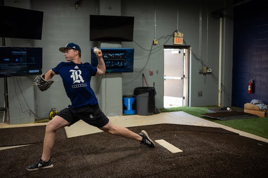 Rice Owls pitcher Tom Vincent throws while his performance is analyzed by various sport analytics software. Trackman captures the ball flight metrics, KinaTrax captures markerless motion and AMTI records ground force measurements. Photo by Jeff Fitlow.