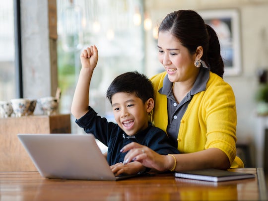 Picture of mother and son reviewing school applications.