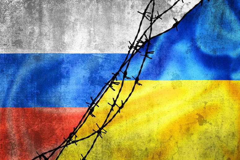 Image of Russian and Ukranian flags separated by barbed wire