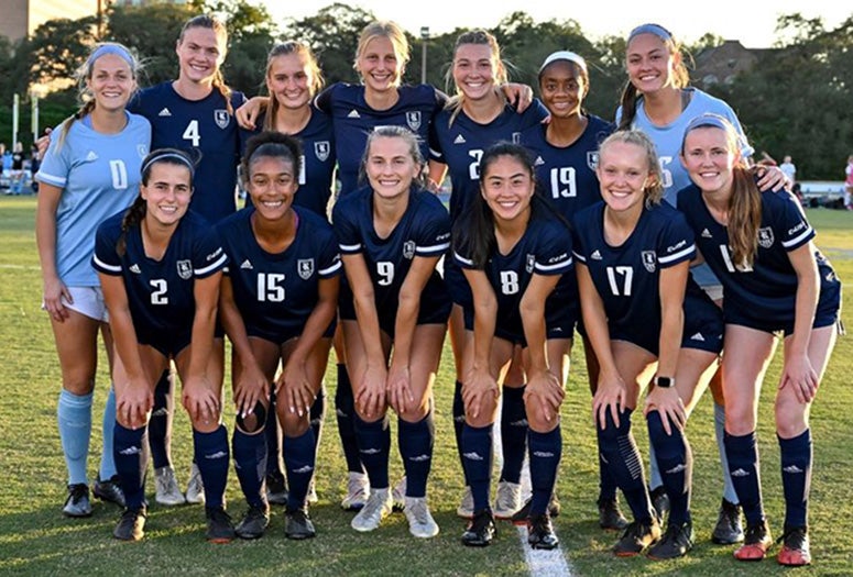 The Rice soccer team poses for a photo.