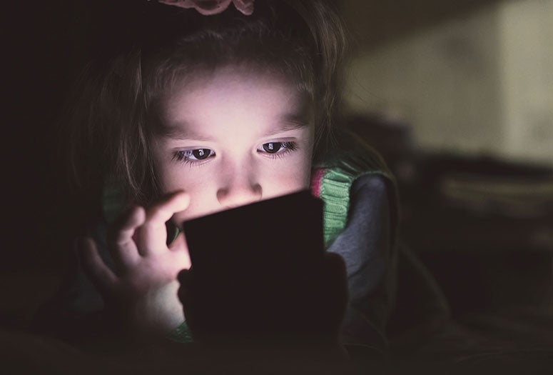 young child using smartphone