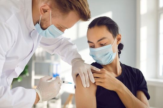 Photo of man getting vaccine.