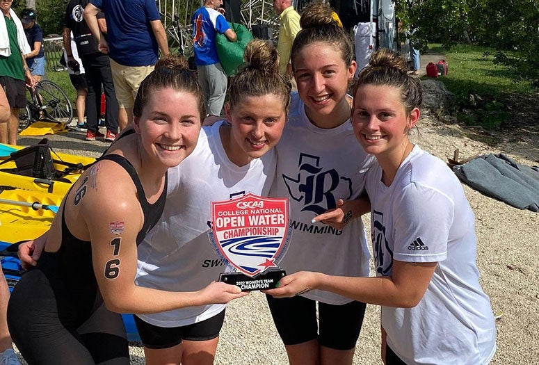 Rice swimmers pose with their trophy after winning the 2022 Open Water Championship in Miami.