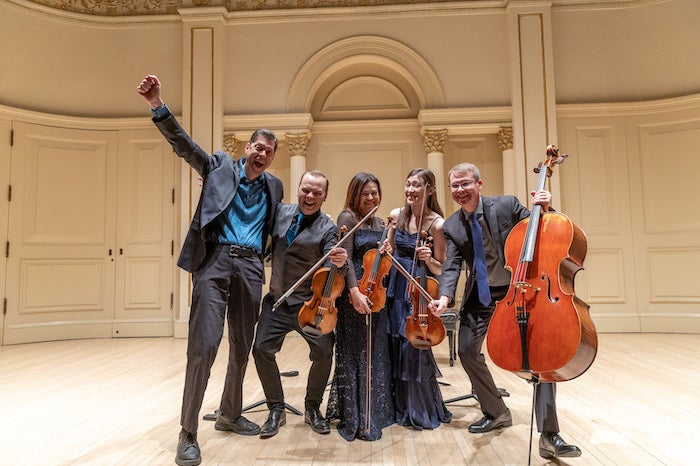 Pierre Jalbert and members of the Apollo Chamber Players celebrate following the group's performance at Carnegie Hall. 