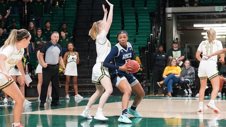 A Rice women's basketball player looks to shoot during a conference game against the University of Alabama at Birmingham.