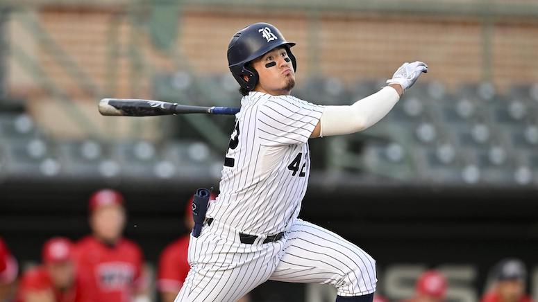 Rice baseball player Manny Garza looks to run for first base after making contact with a pitch.