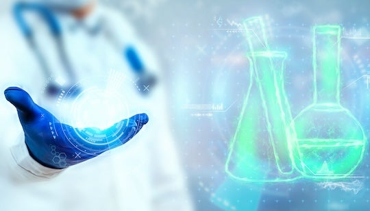 Photo of scientist and laboratory vessels representing STEM.