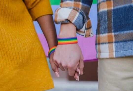 A couple holding hands. Credit: Adobe Stock.