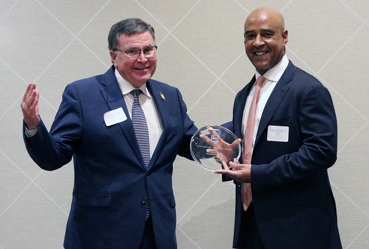 President DesRoches being presented an award