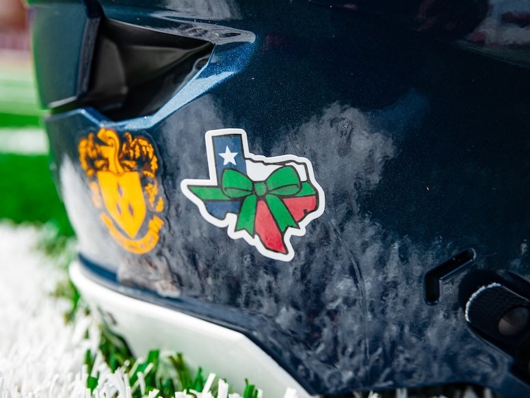 Green ribbon helmet sticker in honor of Texas flooding victims 2025.