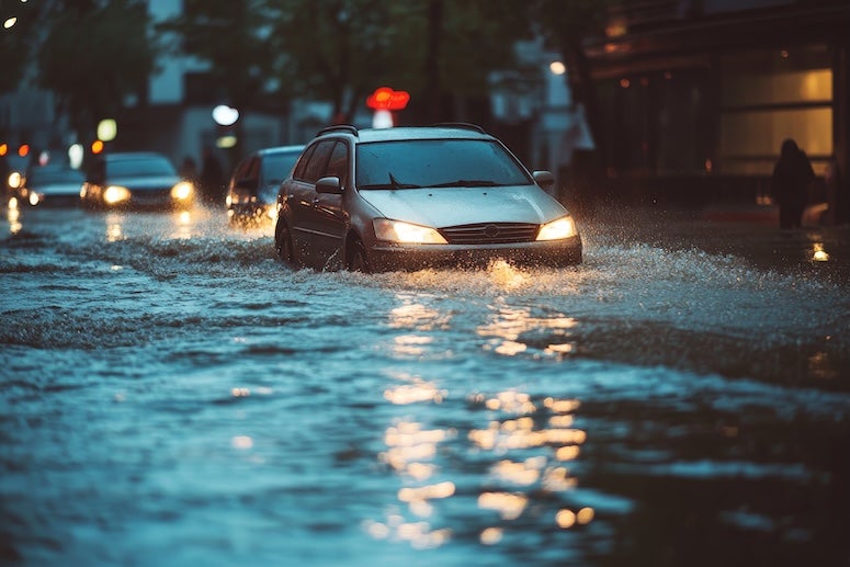 stock photo of car driving in flash flooding