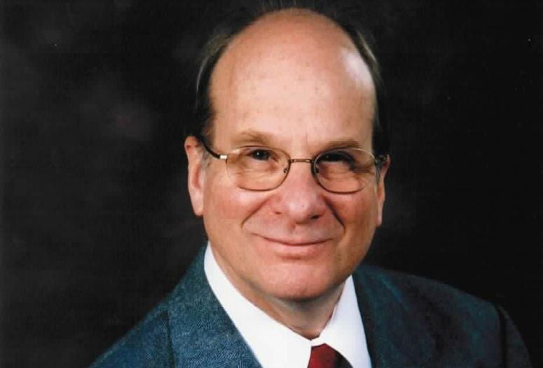 Photo of Louis Brus, a smiling older white man with glasses