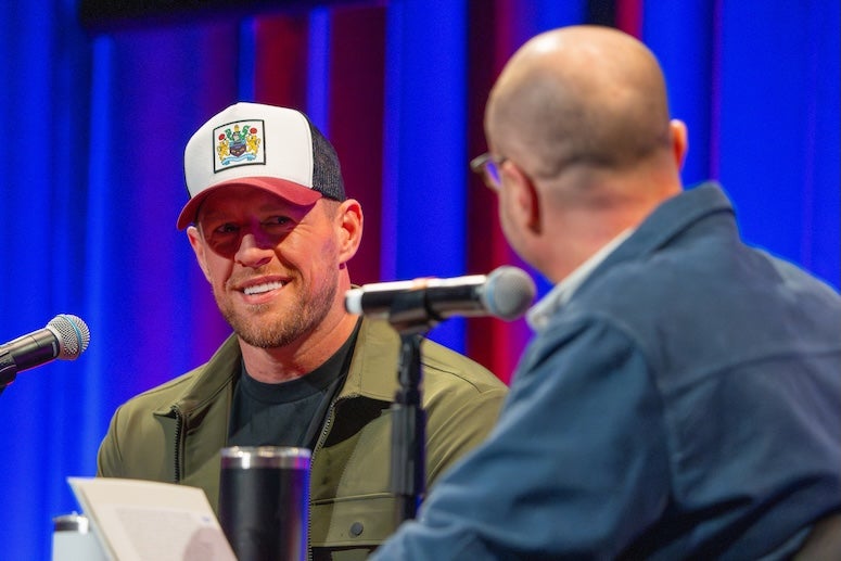 Roger Bennett interviews JJ Watt during a Men in Blazers live podcast at Rice University.