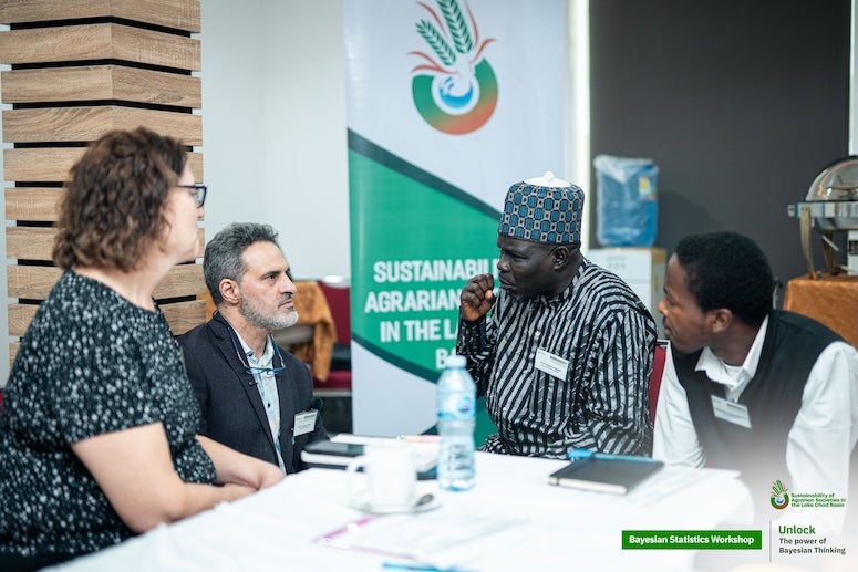 Frederi Viens talking with other researchers