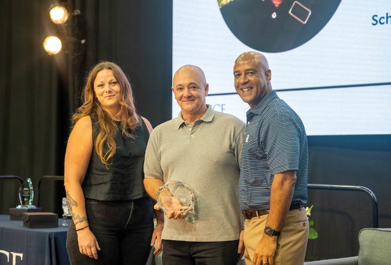Brian Gibson receives the Gillis Award from Jessica Keithan and President Reginald DesRoches.