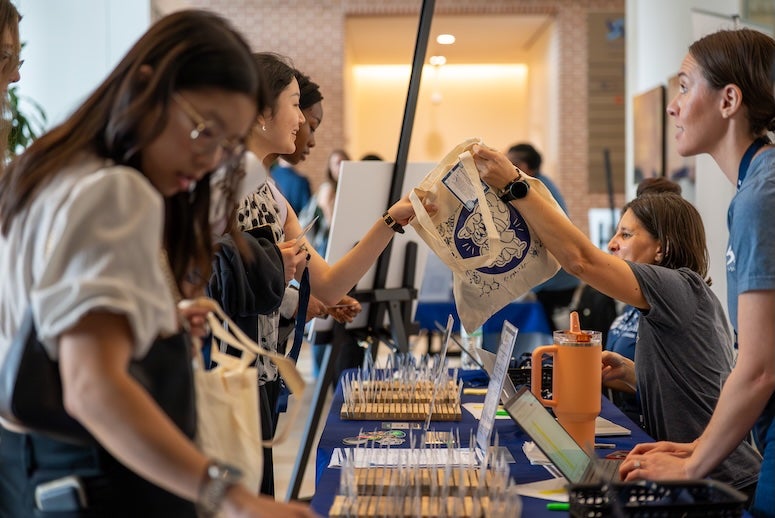 Students check in and receive materials at the Natural Sciences Undergraduate Research Symposium (NSURS) at Rice University’s BioScience Research Collaborative.