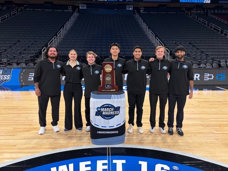 Rice University sport management students pose with the South Regional trophy at Toyota Center, where they worked as court attendants during the Sweet 16 and Elite 8. Photo courtesy of Jacob Lozano