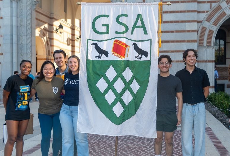 graduate students holding a GSA banner in front of Lovett Hall