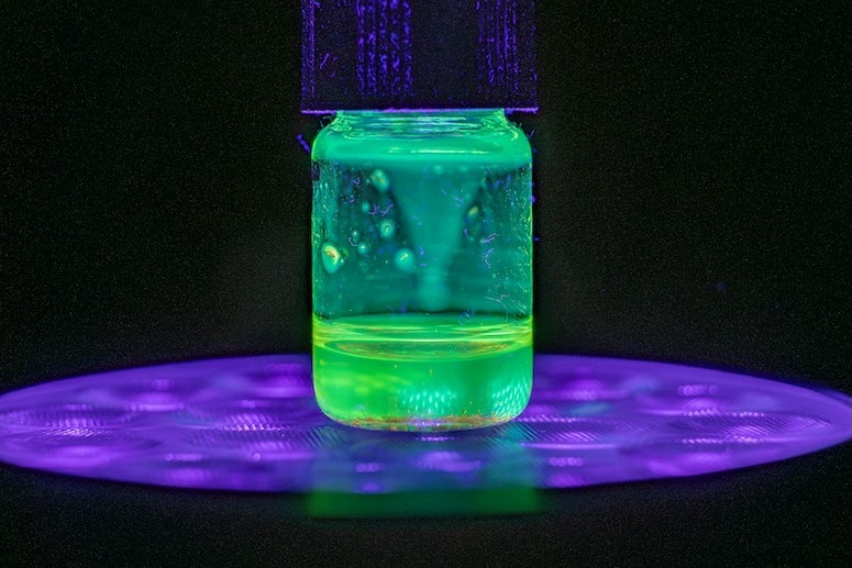a jar with a glowing green liquid inside