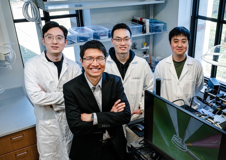 Yong Lin Kong and members of his team standing in his lab