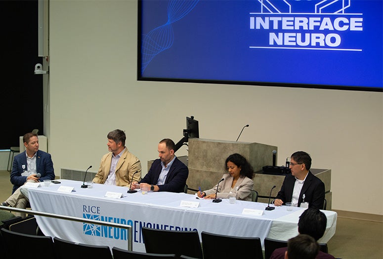 panelists seated at confrence table