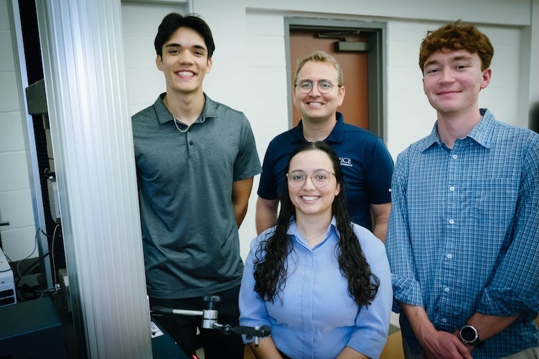 The group of researchers poses for a picture in the lab. 