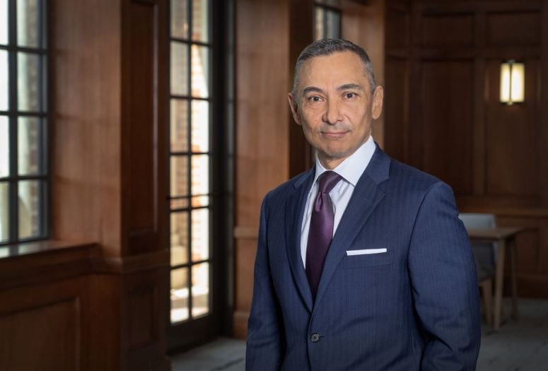 Peter Rodriguez standing in a blue suit