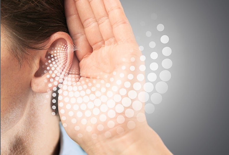 stock photo depicting person holding their hand to their ear
